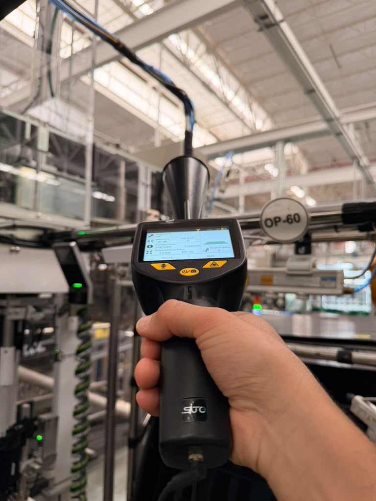 Inspector using SUTO S531 to detect leaks in compressed air network at automotive plant